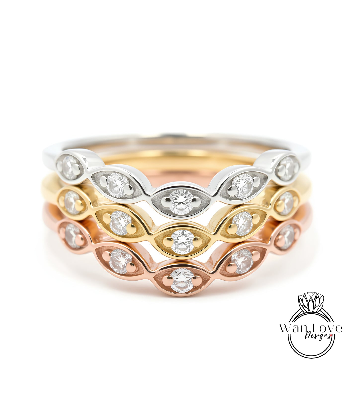 A close-up image of a ring with multiple concentric bands of different colored metals, each adorned with a diamond.