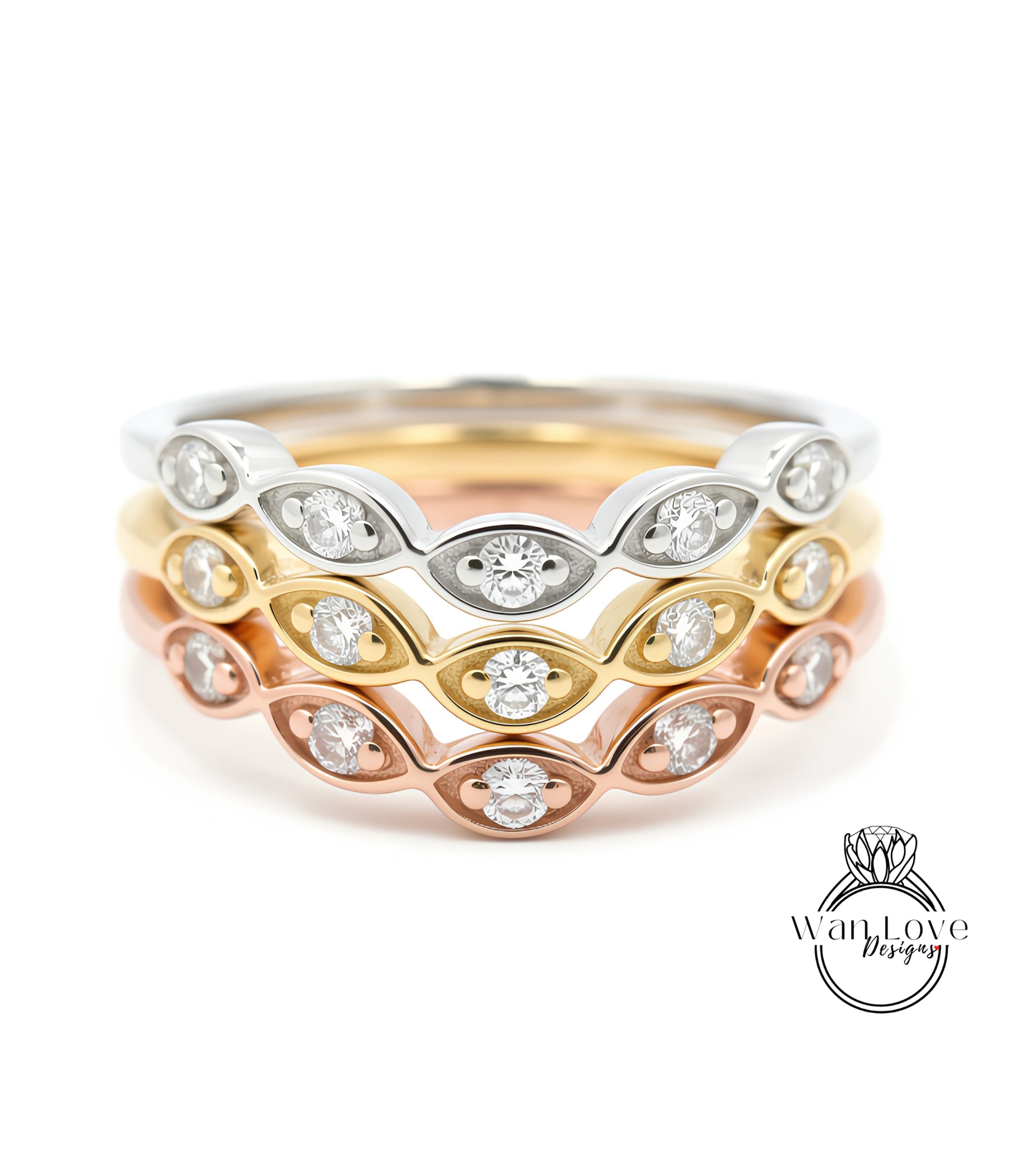 A close-up image of a ring with multiple concentric bands of different colored metals, each adorned with a diamond.