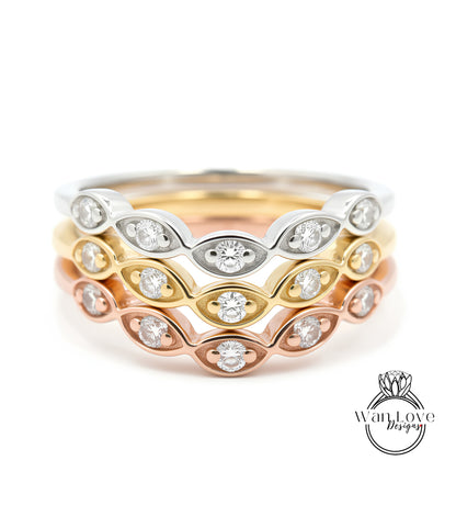 A close-up image of a ring with multiple concentric bands of different colored metals, each adorned with a diamond.