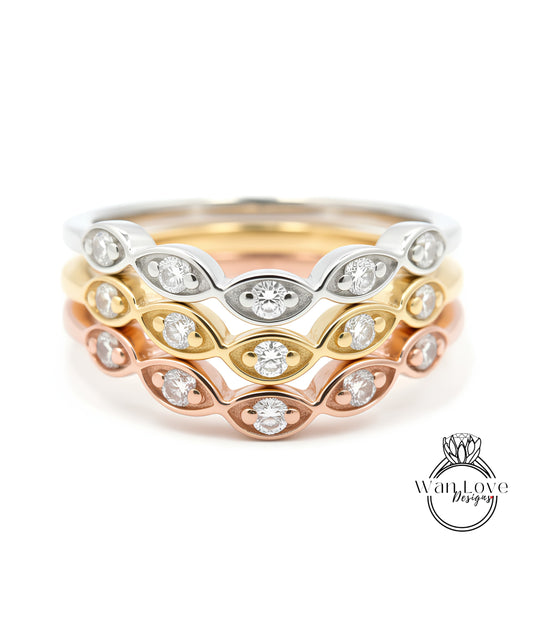 A close-up image of a ring with multiple concentric bands of different colored metals, each adorned with a diamond.