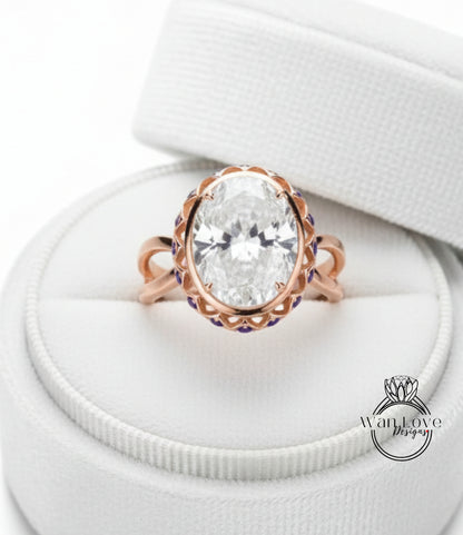 A large oval-shaped diamond ring with a scalloped edge and a large central diamond, displayed in a white jewelry box.