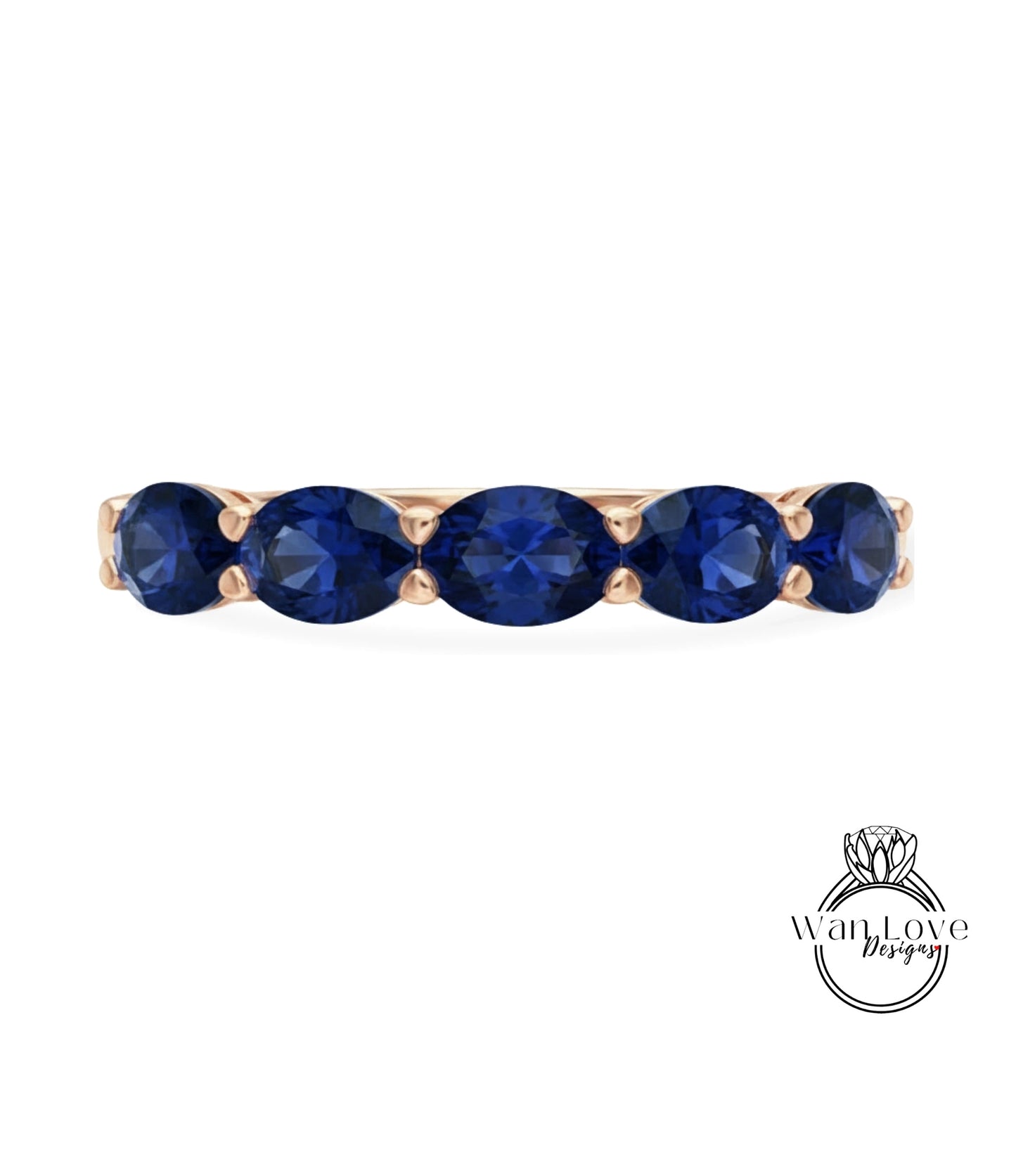 A gold ring with a row of blue sapphire gemstones.