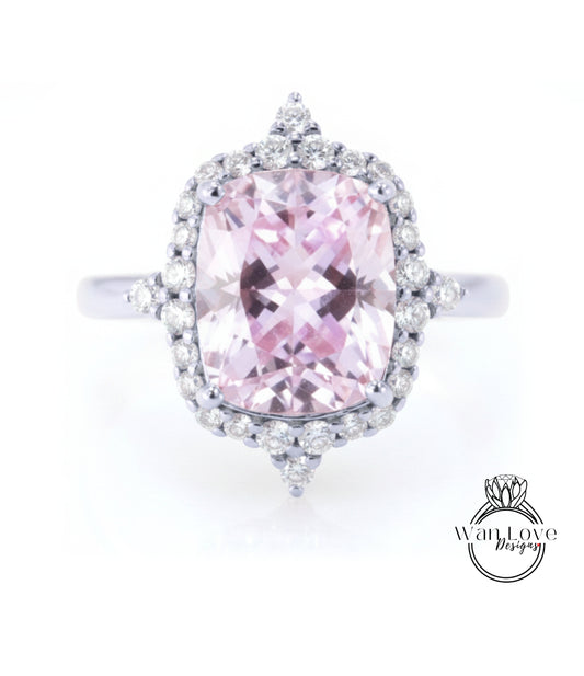 A stunning pink gemstone ring with a halo of sparkling diamonds around it.