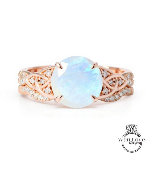 A beautiful engagement ring with a large moonstone set in a rose gold band, adorned with small diamonds.