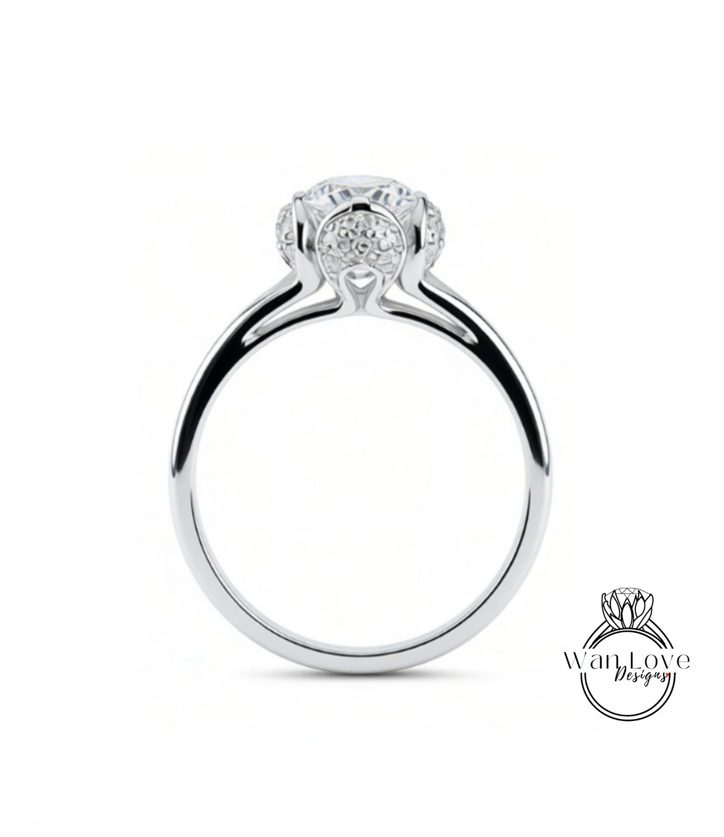 A silver engagement ring with a large central diamond surrounded by smaller diamonds.