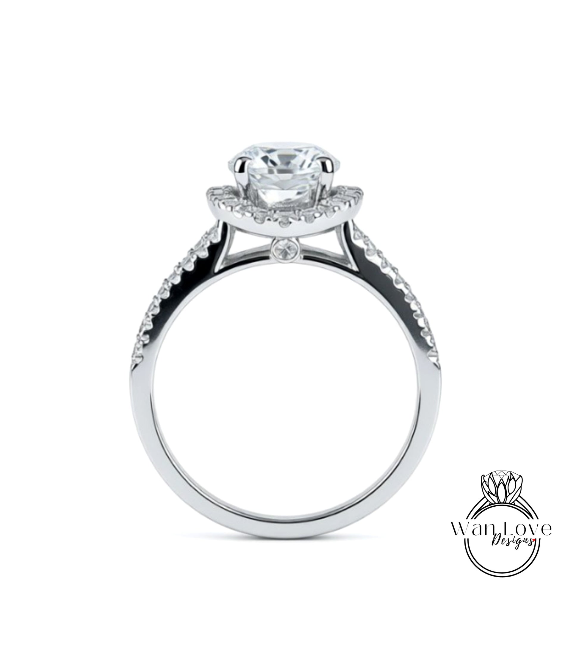 A silver engagement ring with a large central diamond and smaller diamonds on either side of the halo.