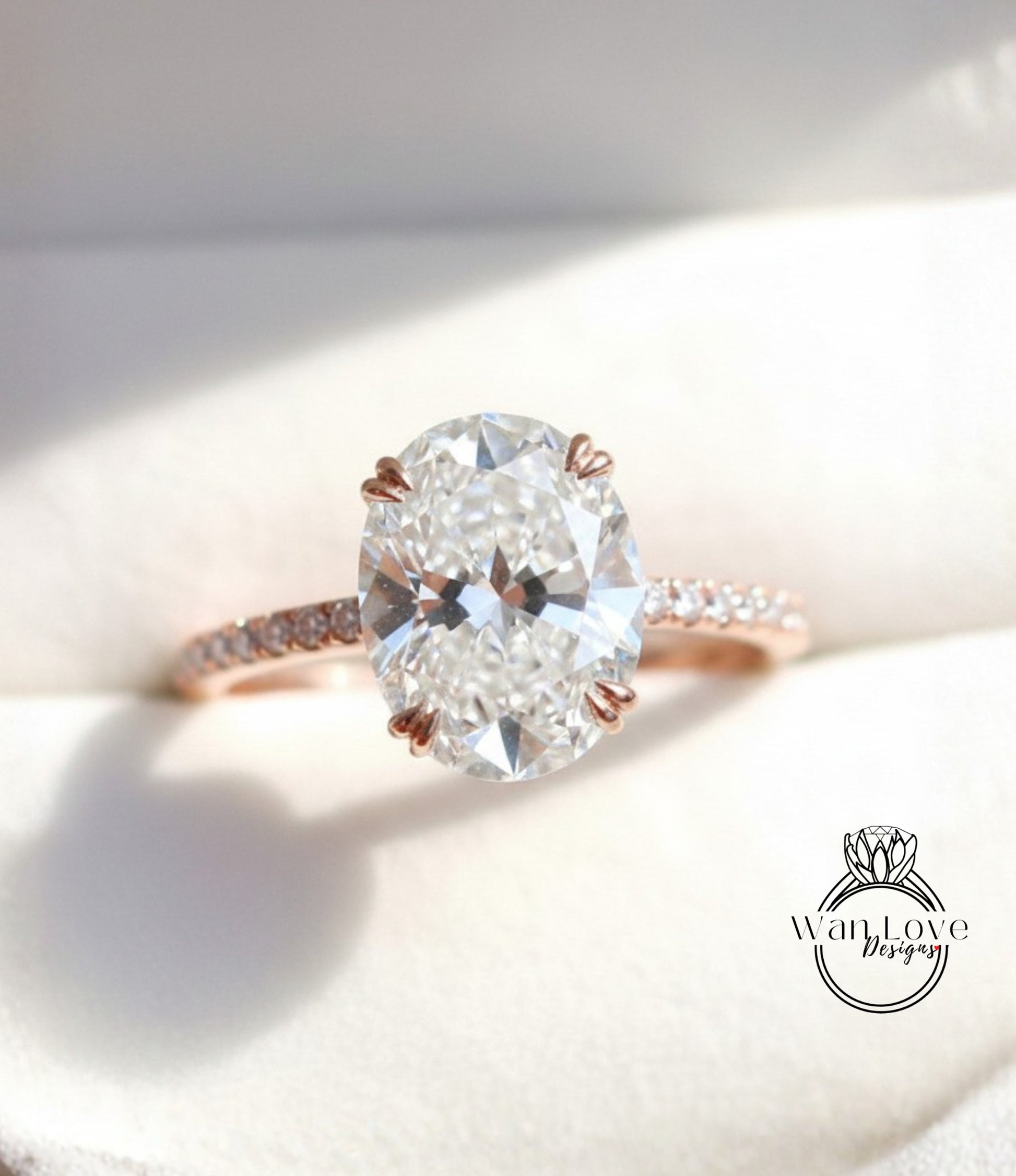 A close-up image of a diamond engagement ring with a large oval-shaped diamond set in a rose gold band.