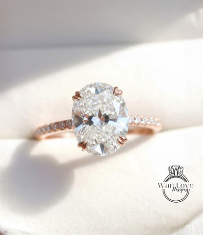 A close-up image of a diamond engagement ring with a large oval-shaped diamond set in a rose gold band.