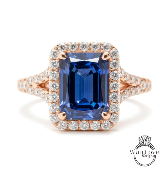 A stunning ring featuring a large blue gemstone surrounded by a halo of smaller diamonds, set in a rose gold band.
