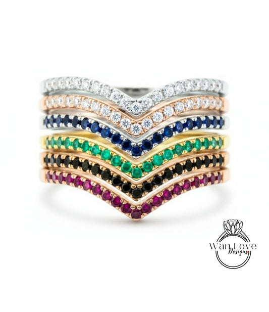 A ring with a series of colorful gemstone bands stacked on top of each other, showcasing a variety of gemstones in different colors.