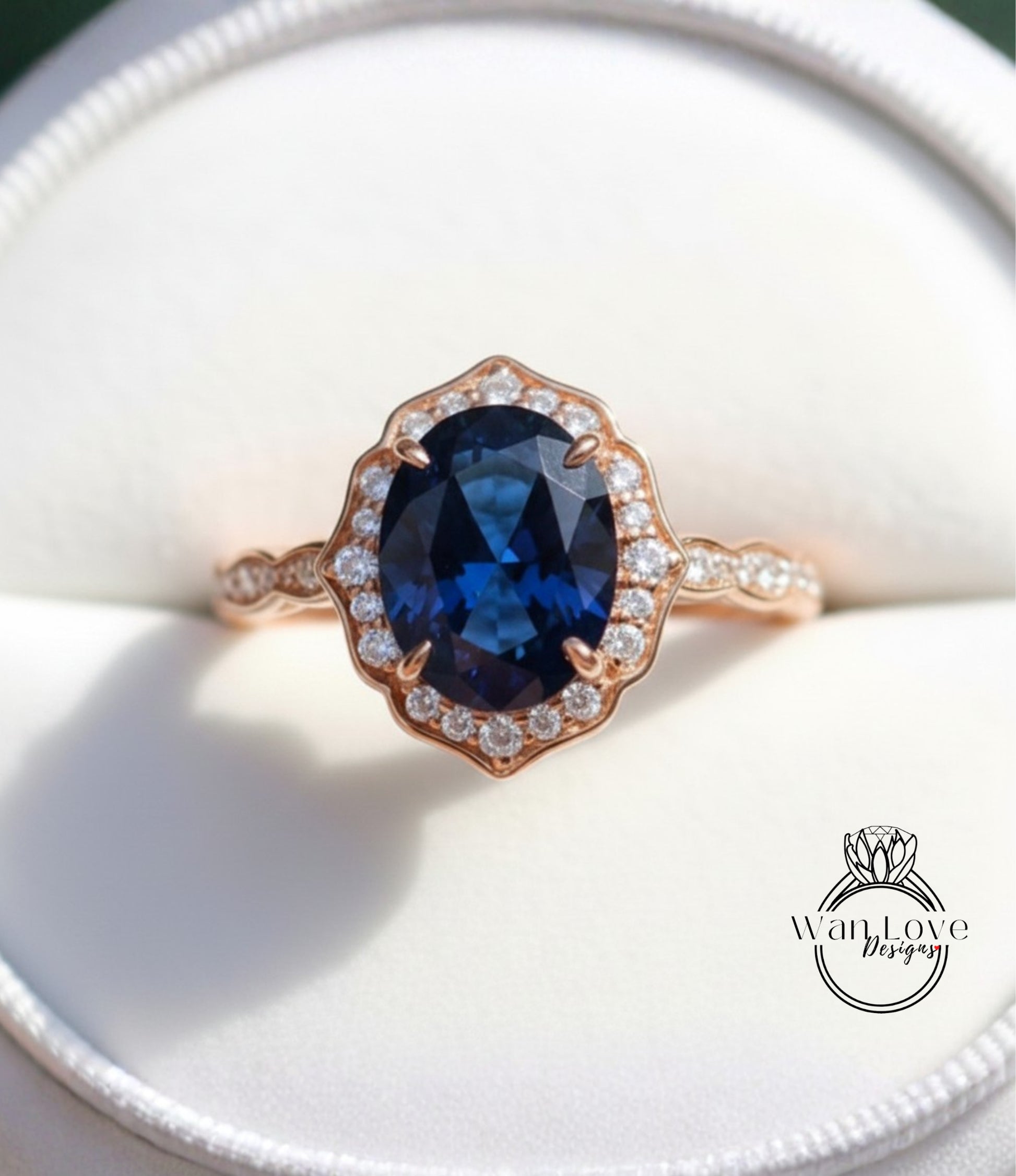 A close-up image of a gold ring with a large oval-shaped blue gemstone set in the center, surrounded by smaller diamonds.