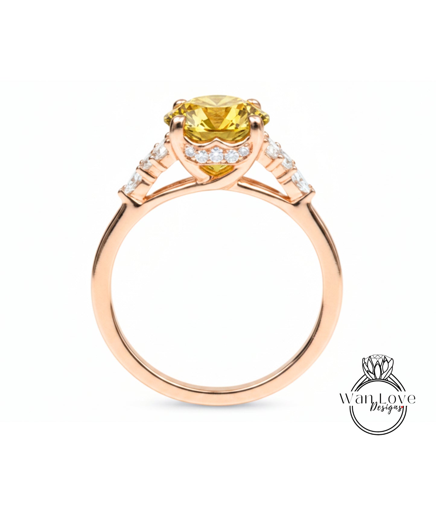 A gold ring with a yellow gemstone, possibly a diamond, set in the center.