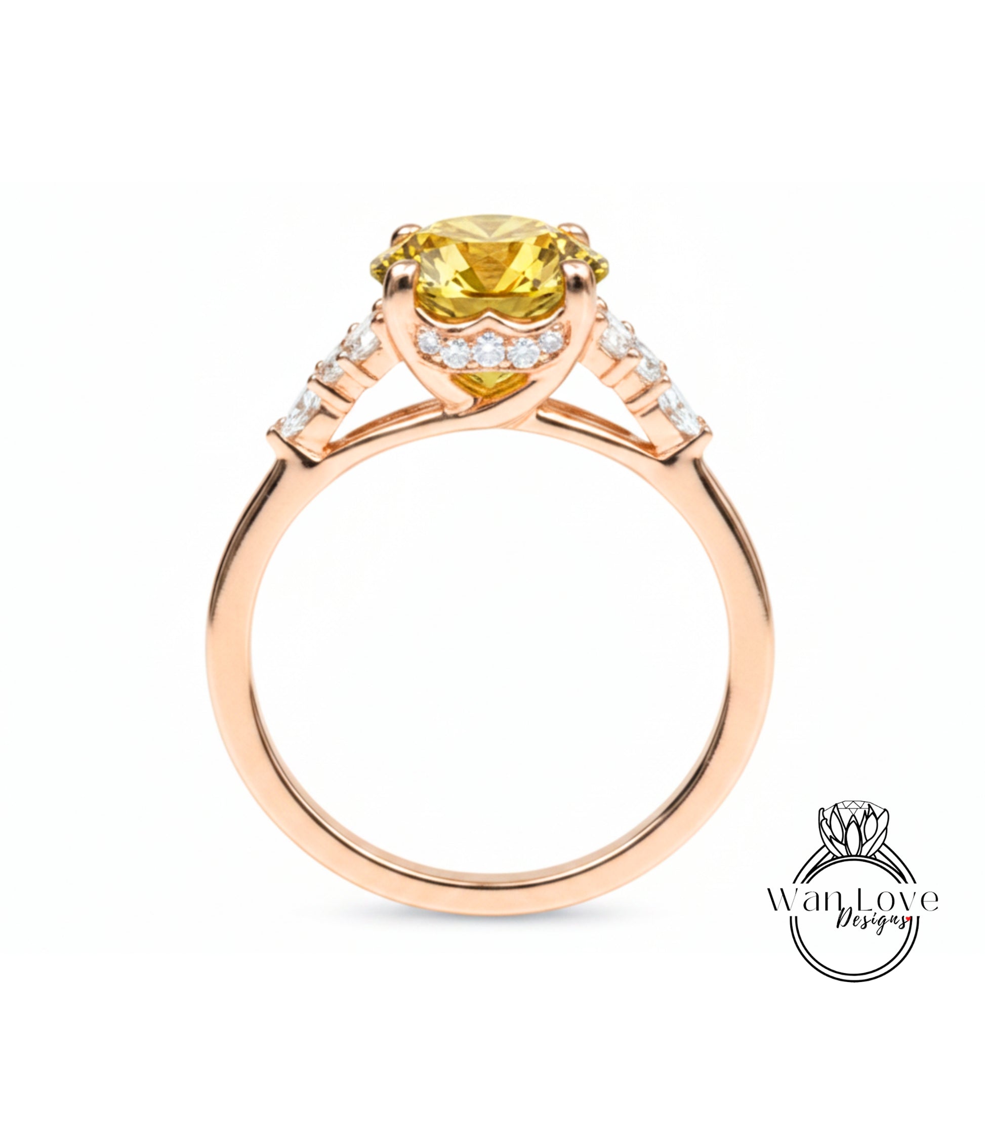 A gold ring with a yellow gemstone, possibly a diamond, set in the center.