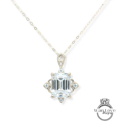 A necklace with a large, clear gemstone pendant.