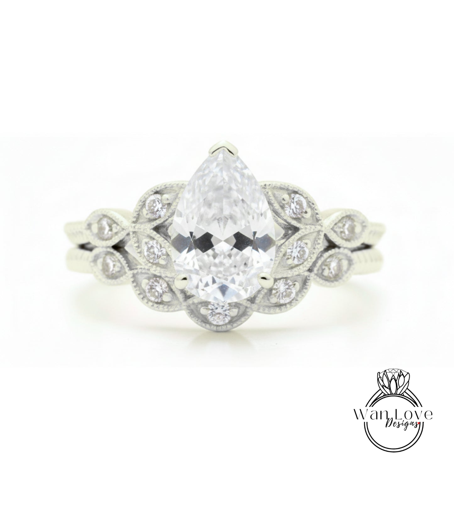 A close-up of a diamond engagement ring with a large pear-shaped diamond at the center, surrounded by smaller diamonds.