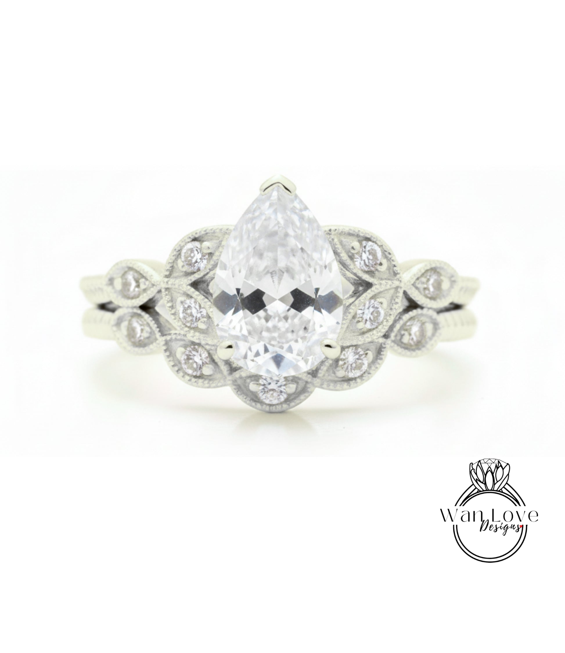 A close-up of a diamond engagement ring with a large pear-shaped diamond at the center, surrounded by smaller diamonds.