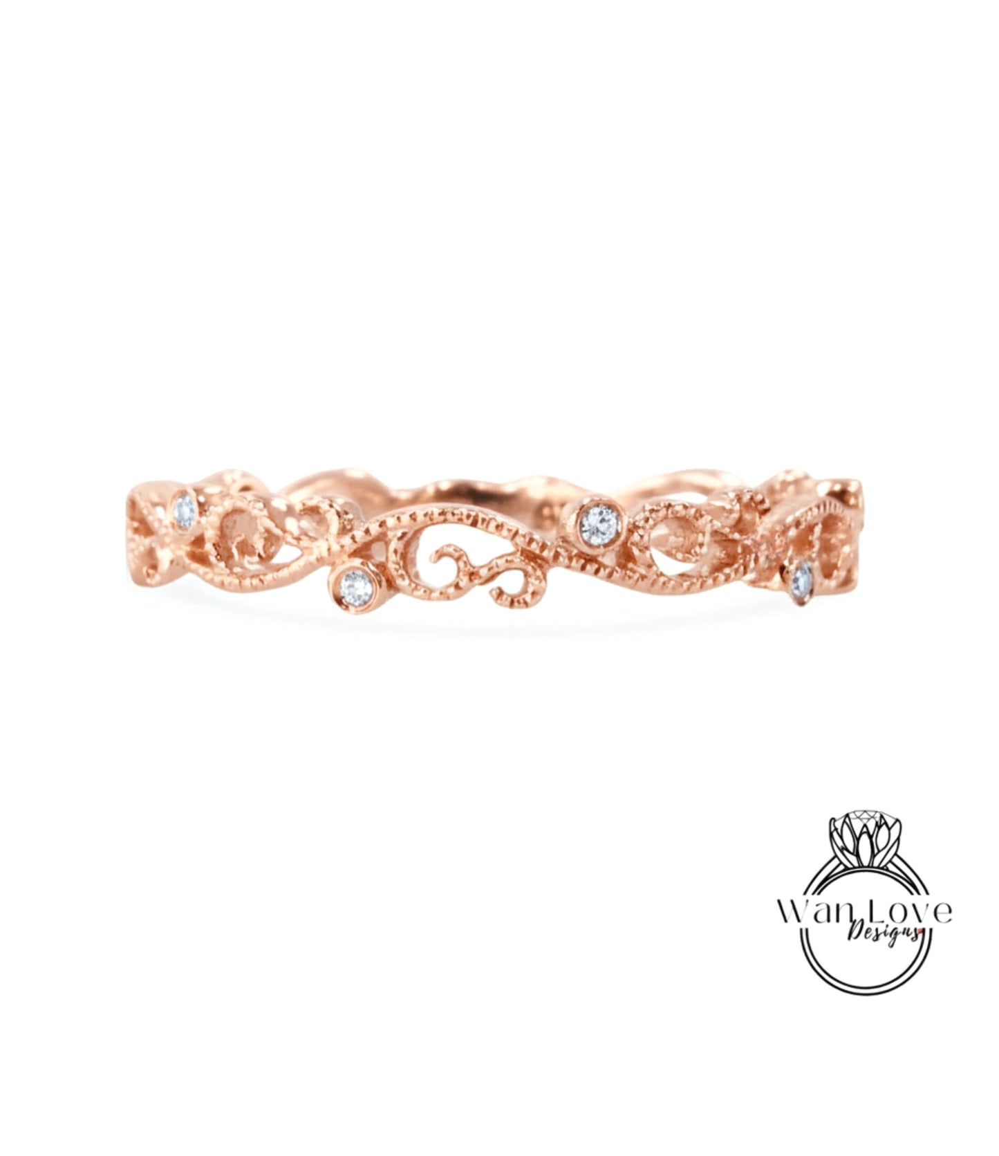 A rose gold ring with a delicate floral design and small diamonds set in the center.