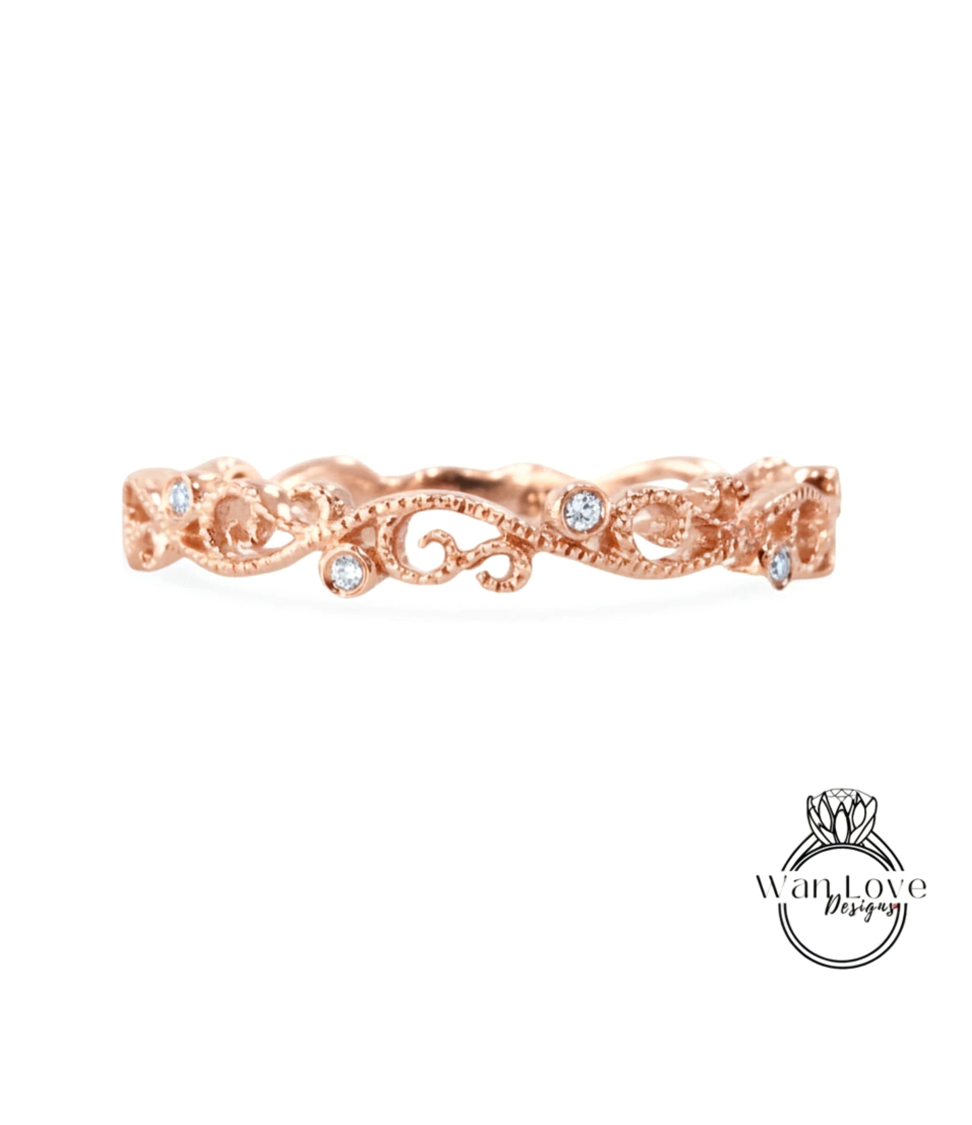 A rose gold ring with a delicate floral design and small diamonds set in the center.