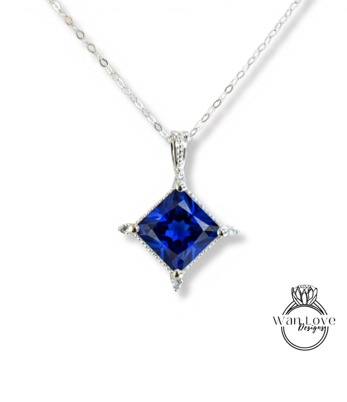A silver necklace with a large blue gemstone pendant.