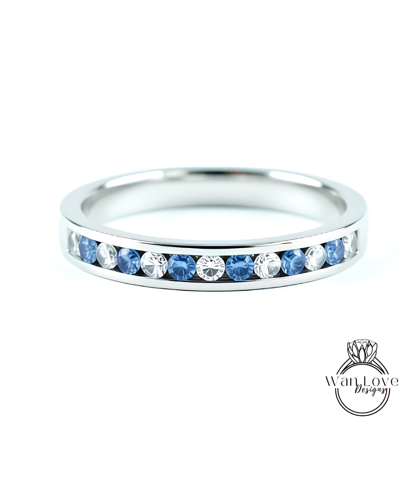 A silver band ring with a row of blue sapphires set in the center.