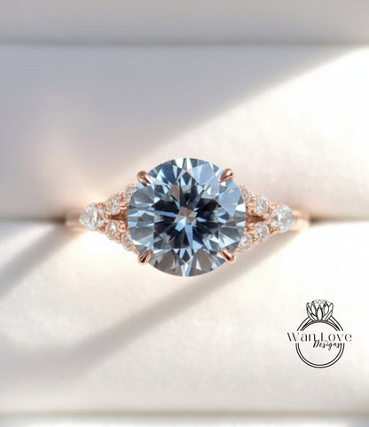 A close-up view of a beautiful engagement ring with a large, round blue diamond set in a rose gold band adorned with smaller diamonds.