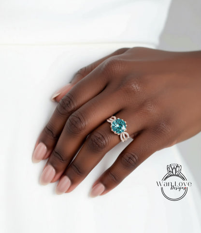 A close-up of a hand wearing a ring with a large blue gemstone.