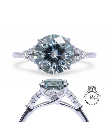 A stunning engagement ring with a large, round brilliant blue diamond set in a silver band, surrounded by smaller diamonds.