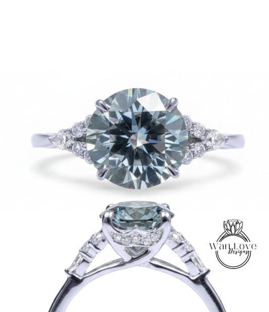 A stunning engagement ring with a large, round brilliant blue diamond set in a silver band, surrounded by smaller diamonds.