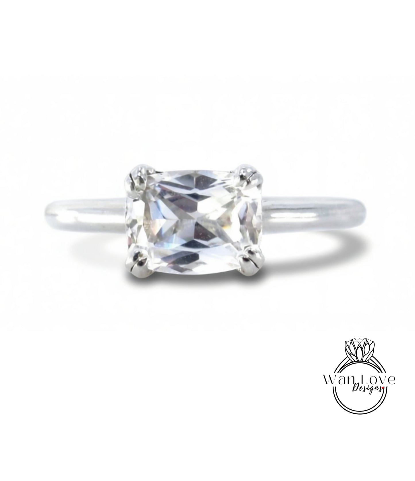 A close-up view of a diamond engagement ring with a large, clear gemstone set in a silver band.