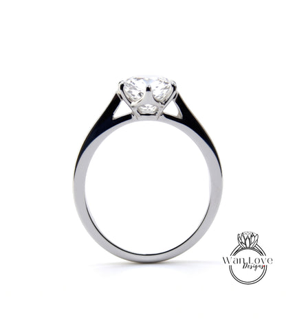 A silver engagement ring with a large central diamond set in a solitaire style.