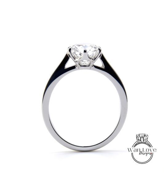 A silver engagement ring with a large central diamond set in a solitaire style.