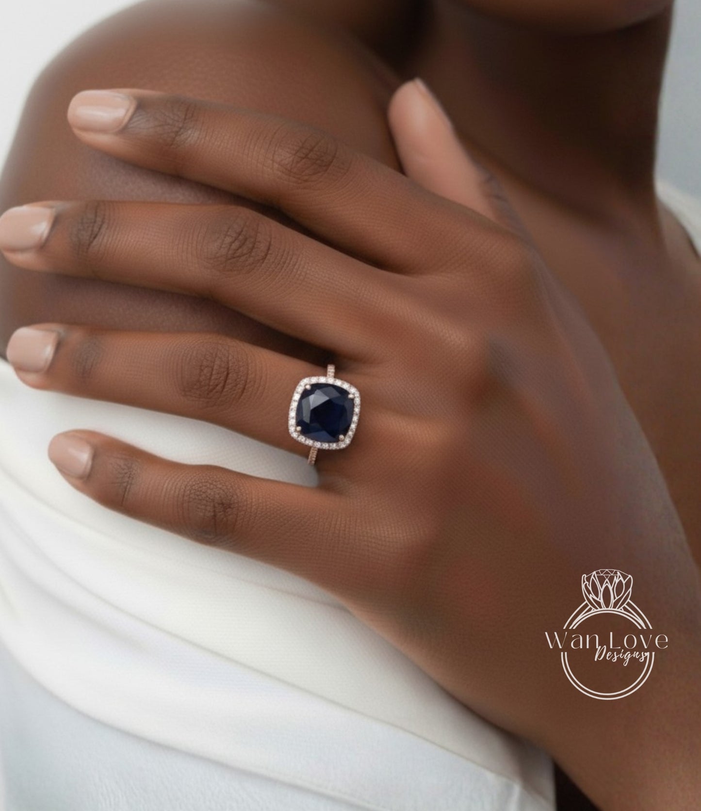A close-up of a person's hand wearing a ring with a large blue gemstone.