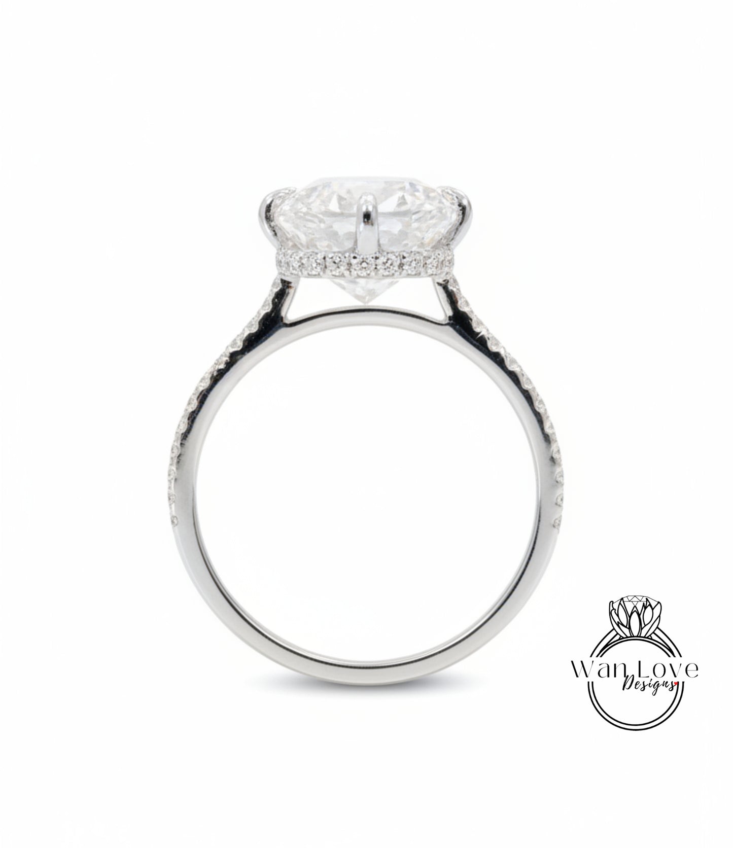 A silver engagement ring with a large, round diamond set in the center, surrounded by smaller diamonds along the band.
