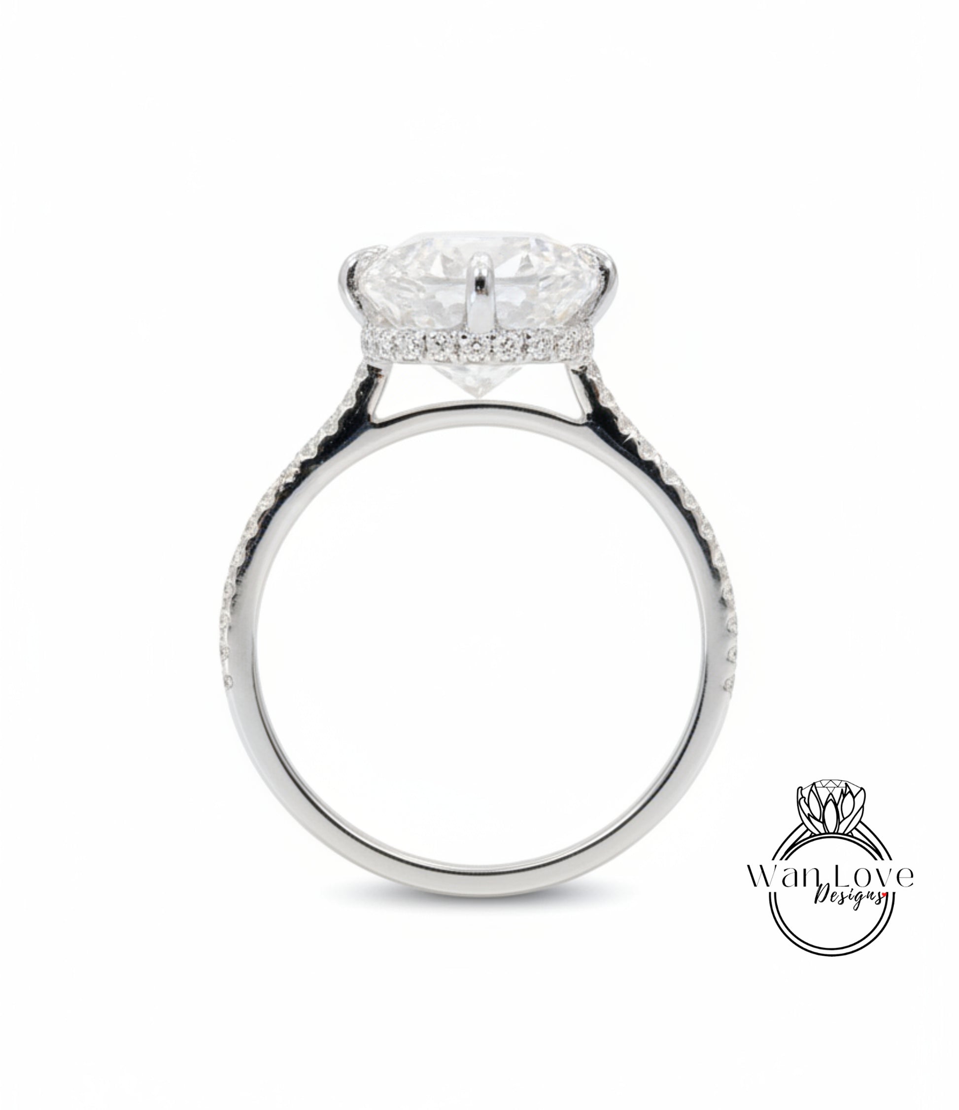 A silver engagement ring with a large, round diamond set in the center, surrounded by smaller diamonds along the band.