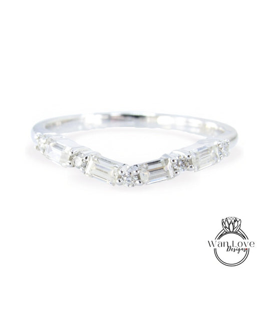 A silver ring with a unique design featuring a series of small diamonds arranged in a curved pattern.