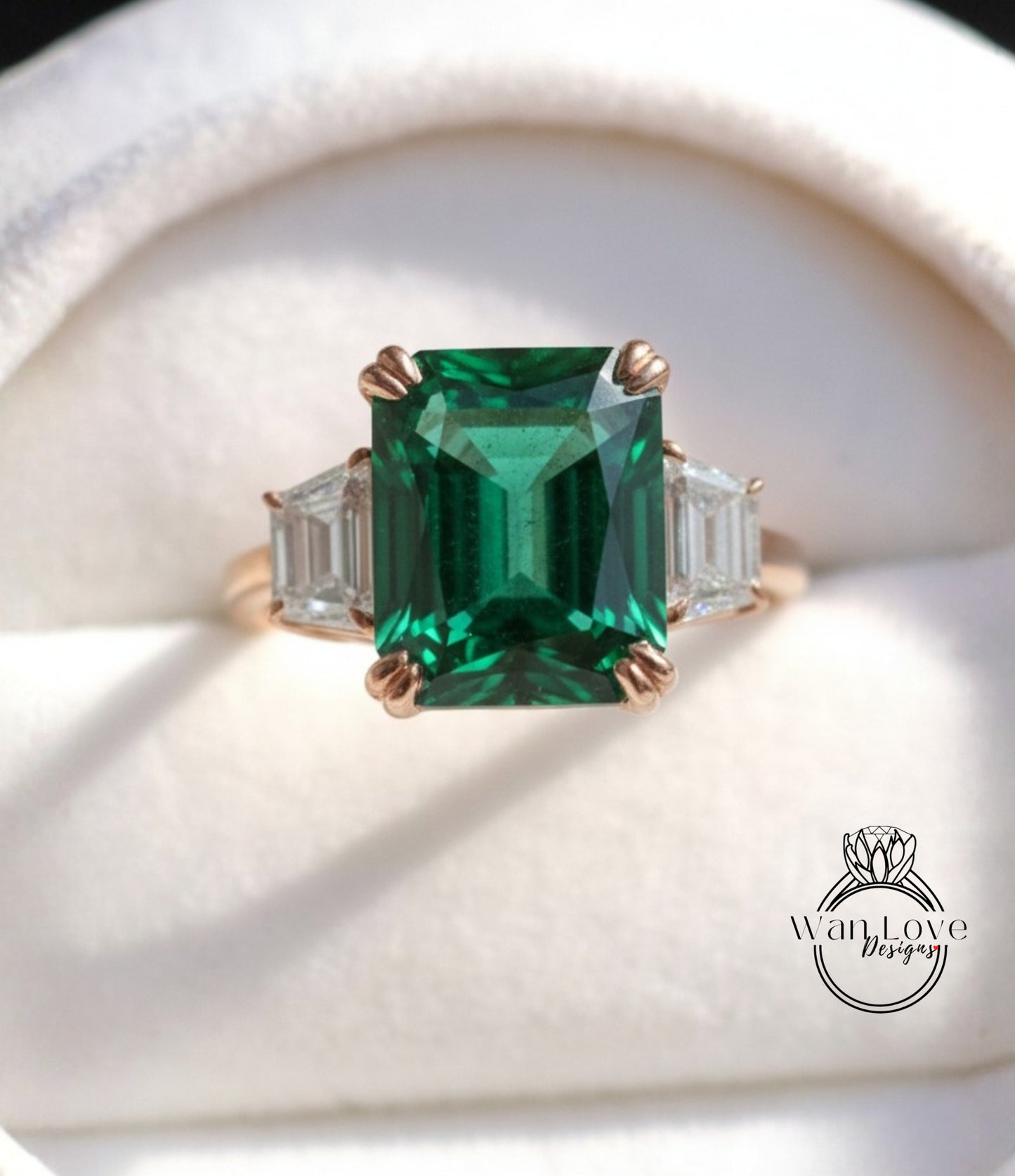 A close-up image of a gold ring with a large, green gemstone in the center, surrounded by smaller diamonds.