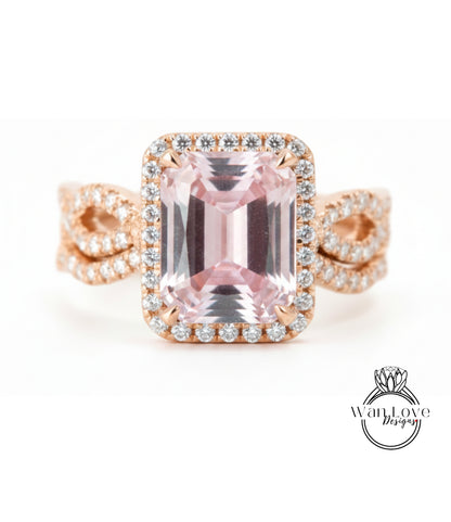 A beautiful pink gemstone ring with a halo of diamonds around it, set in a rose gold band.