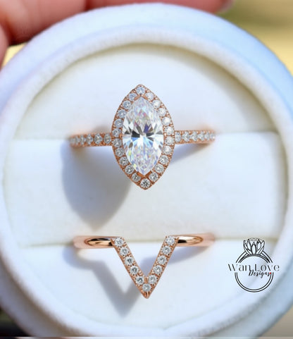 A close-up view of a diamond engagement ring, showcasing a large central diamond surrounded by smaller diamonds on the band and a smaller diamond-encrusted ring below it.