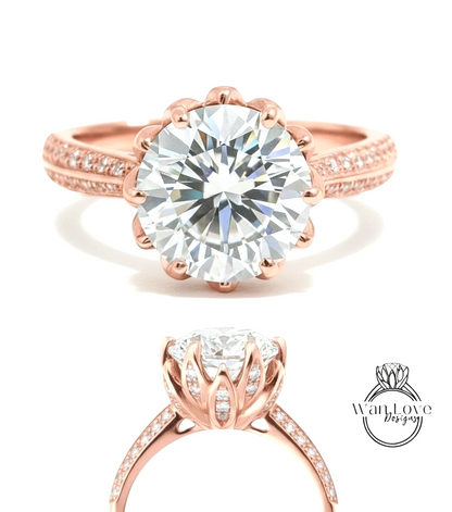 a beautiful rose gold engagement ring with a large, brilliant-cut diamond set in the center. The ring has a scalloped band and is adorned with small diamonds around the band.
