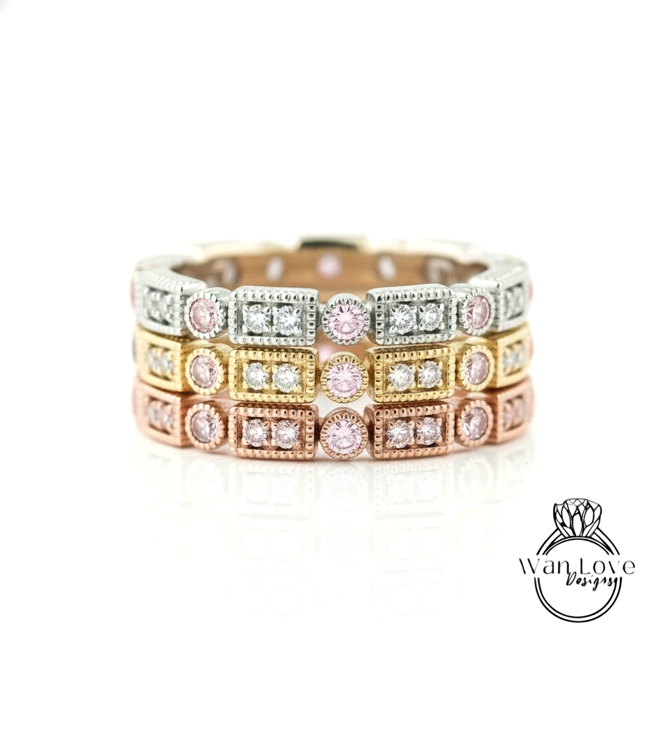 A close-up image of a ring with multiple layers of rings, each with a diamond set in a different colored gemstone.