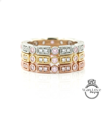 A close-up image of a ring with multiple layers of rings, each with a diamond set in a different colored gemstone.