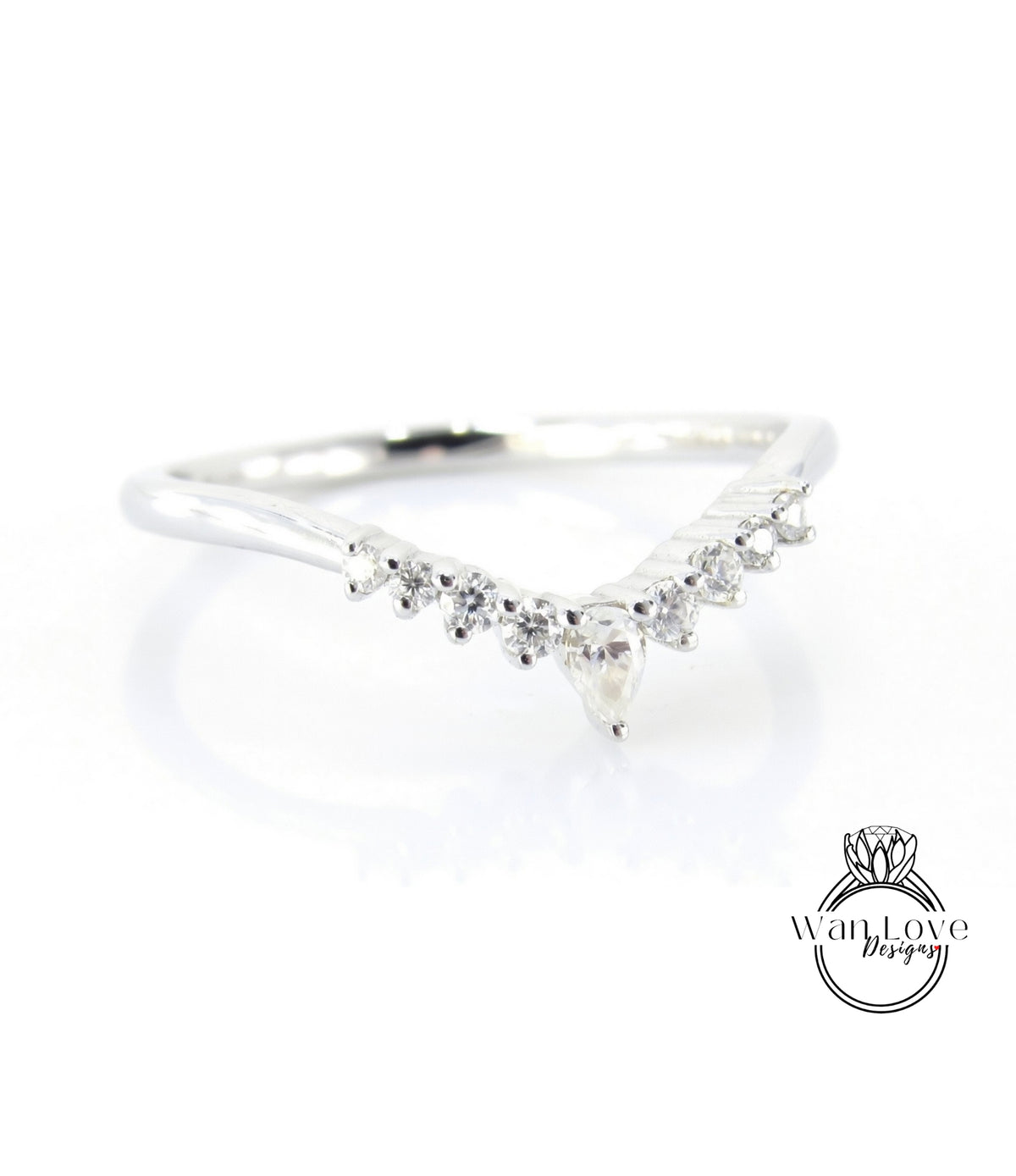 A silver ring with a diamond-encrusted band featuring a v-shaped design with a central pendant.