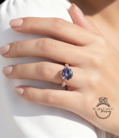 A close-up of a person's hand wearing a ring with a large purple gemstone.