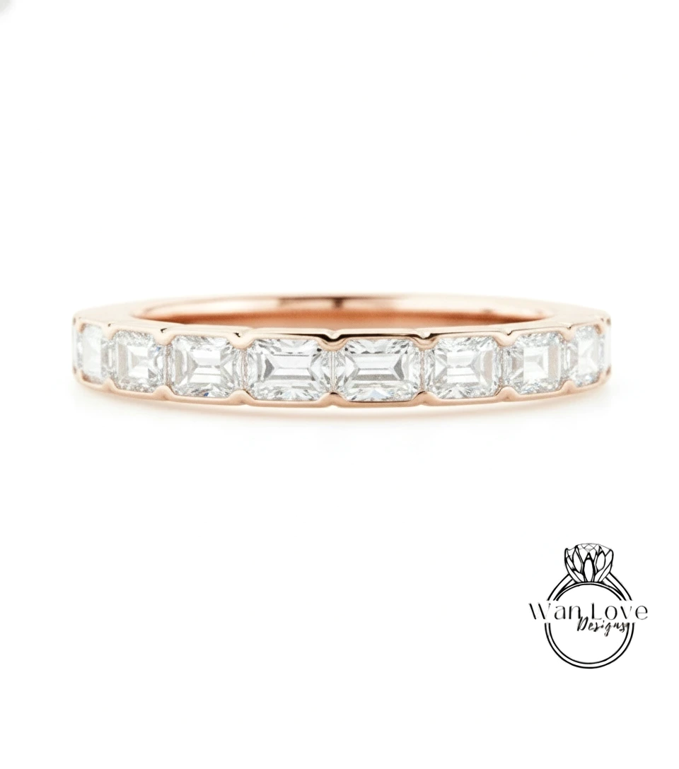 A rose gold band with a row of clear gemstones, likely diamonds, set in the center.