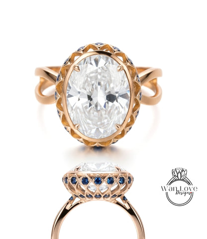a large, oval-shaped diamond ring with a gold band and a blue and white floral design around the center stone.