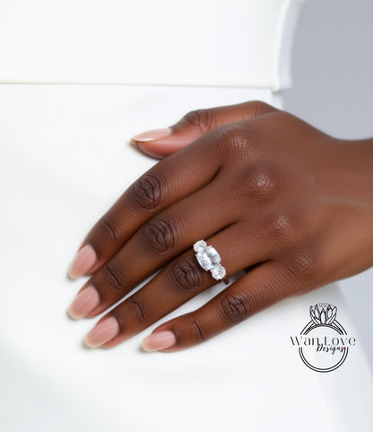 A close-up of a hand wearing a diamond ring on the ring finger.