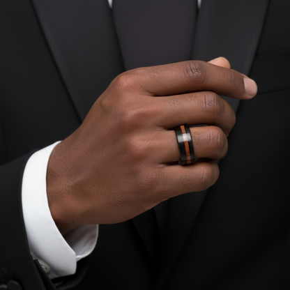 A close-up of a person's hand wearing a ring on the ring finger.