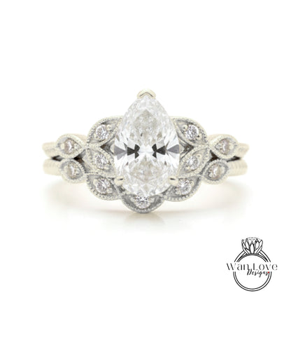 A close-up of a diamond engagement ring with a large central diamond surrounded by smaller diamonds on either side, set in a silver band.