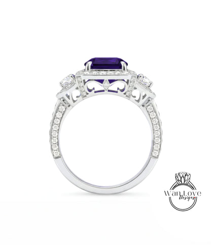 A silver ring with a large purple gemstone, surrounded by smaller diamonds and intricate designs.