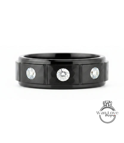 A black ring with three diamonds set in the center.